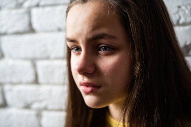Portrait of a crying child with tears, close-up. The kid is crying