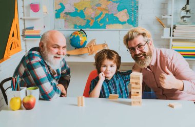 Baba ve oğul torunla Jenga oynuyorlar. Mutlu adamlar aileyi sever. Erkek nesiller boyu arkadaşlık. Erkekler ailesi