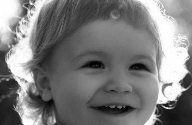 Portrait of a happy laughing child. Close up positive kids cropped face. Baby smiling, cute smile