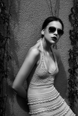 Vogue sunglasses. Beautiful young woman posing. Sensual model girl with glasses and makeup