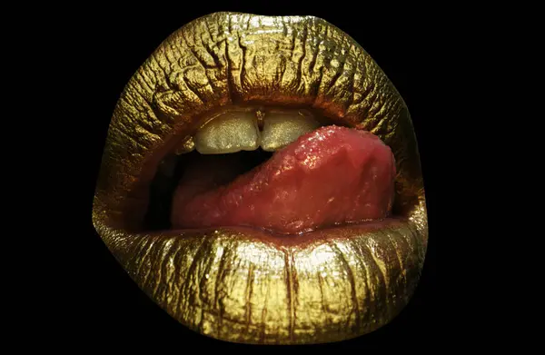 Sexy tongue. Sensual lick. Sexy girl golden lips, gold mouth. Glowing gold skin make-up. Glitter metallic shine golden lipgloss makeup