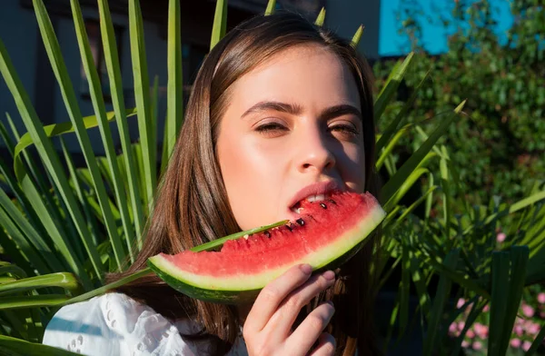 Portrait of a happy young woman with watermelon. Youth lifestyle. Happiness summer holiday. Tropical vacation travel concept. Happy young woman with watermelon in park