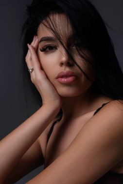 Beauty portrait of young woman. Sexy model posing in studio. Portrait of beautiful girl. Beauty woman face close up. Pretty girl portrait on studio background. Sensual look. Beautiful female portrait
