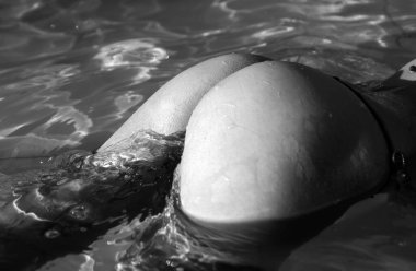 Summer vacation. Sexy woman ass buttocks. Girl in bikini on sea water background with copyspace. Sexy buttocks