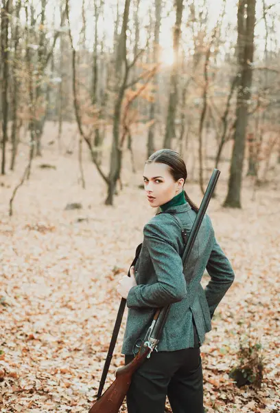 Hunter woman hunting. Hunting in autumn forest. Portrait of beauty woman Hunter. Hunting season