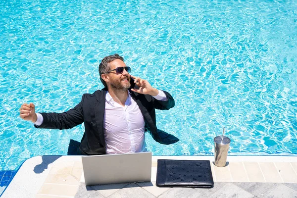 Hot excited business. Funny excited office worker. Business man in suit work online in beach. Travel and business. Crazy excited office worker. Excited businessman on summer work. Summer dream