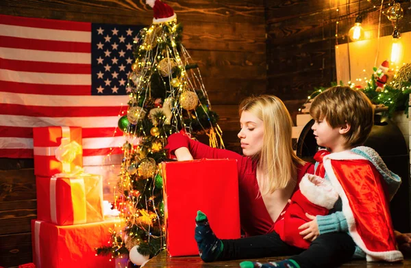 Family having fun at home. Happy family. Family holiday. Mom and kid decorating together christmas tree. Mother and son friendly having fun. Enjoy every moment together. American traditions concept.