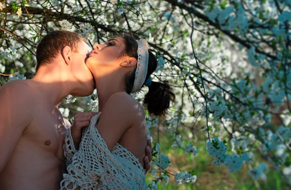 Love story. Spring couple in love. Summer happiness. Sensual lovers in cherry blossom tree