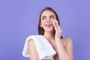Beauty model cleansing her perfect skin by cotton pad sponge. Spa and wellness, skin care. Evening beauty routine. Beautiful woman cleaning her face with cotton pad. Skin treatment, cosmetology