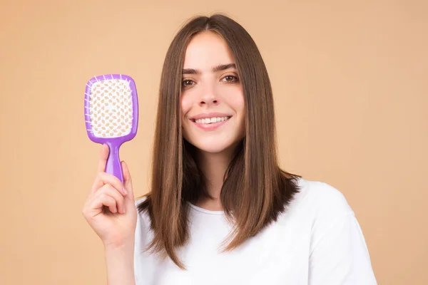 stock image Young woman combing healthy and natural shiny hair, isolated on studio. Beauty hair care