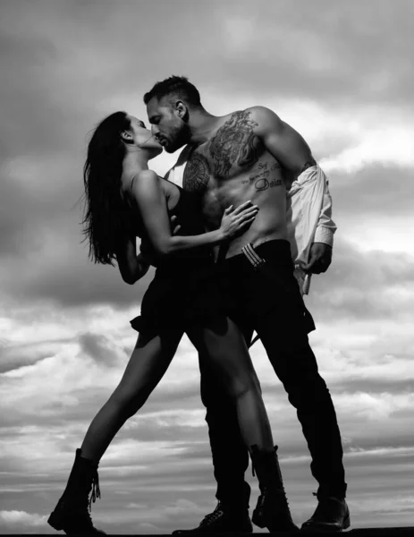 Beauty couple of young lovers kissing gently. Young sexual couple of attractive woman naked muscular man with muscular torso. Sensual kiss. Man kissing sensual woman