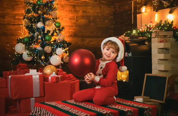 Gelukkig Kind Draagt Santa Kleding Met Grote Rode Kerstballen Kerstkind — Stockfoto