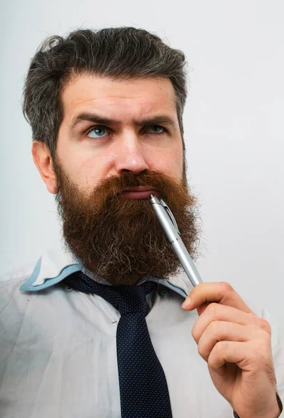 Concentrated man with pen in his mouth. He is thinking. Business concept. Escape from crisis. Funny face. Great Idea