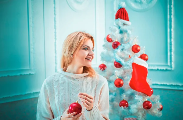 Home Christmas atmosphere. Christmas young woman. Winter holidays and people concept. Christmas preparation. We wish you a merry christmas tree