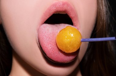 Close up lips with lollipop isolated, sexy blowjob, sensual mouth with lipstick eats sweets. Sexy design for women and girls. Beautiful lips