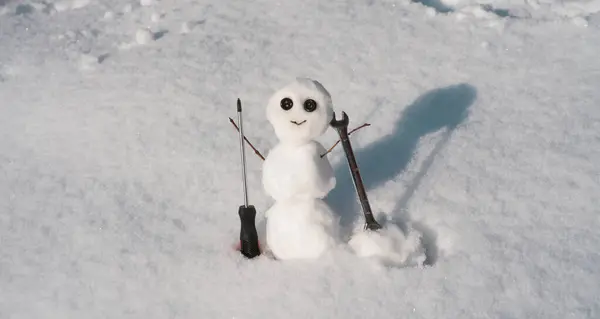 Snow man. Happy snowman on snow, funny winter time. Repairman with wrench and screwdriver. Support repair and recover service
