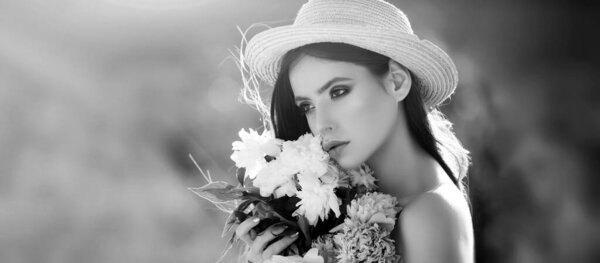 Outdoor fashion photo of beautiful young woman in flowers. Sensual girl on spring blossom background. Banner for header website design, copy space