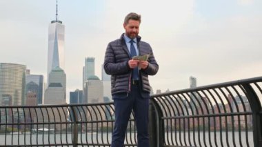 Sonbaharda işadamı New York 'ta para saymaya başladı. Dışarıda parası olan bir iş adamı. Takım elbiseli zengin iş adamı elinde para tutuyor. Dolarlı heyecanlı iş adamı başarıyı kutluyor.