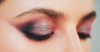 Kadınların gözlerini parlak mor dumanlı göz makyajıyla kapat. Stüdyodaki profesyonel makyözden lüks makyaj malzemeleri. Vogue, kozmetik ve cazibe konsepti