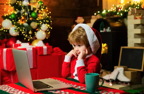 stock image Family with kids celebrating Christmas at home. New Year surprise present. Joy and happiness. Boy child with laptop near christmas tree. Santa little helper. Gifts service