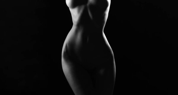 Woman sexy perfect body shape. Nude sexy woman. Perfect naked body of sexy lady. Fashion art photo of elegant nude model in the light colored spotlights
