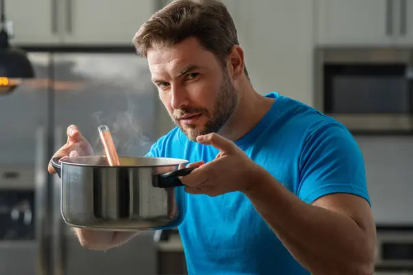Chef cook cooking soup at kitchen. Chef cook prepares a soup bowl with soup pot. Soups recipe. Chef cooking soup in modern kitchen. Mature chef man standing in kitchen, preparing food