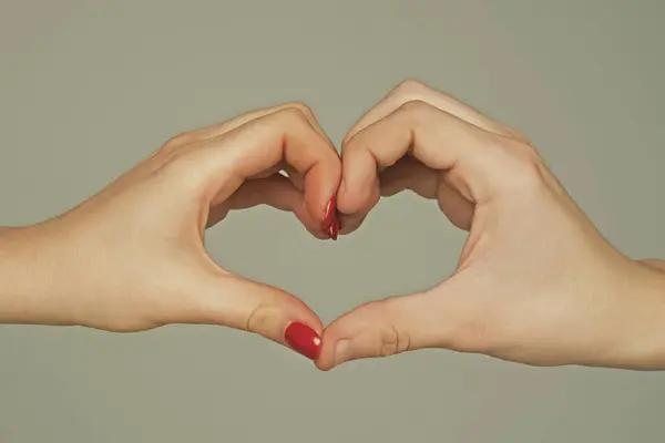 Heart from hands. Love, friendship concept. Man and woman hand in heart form love. Sign heart by fingers. Love on Valentine day. Two human hold hand gesturing heart shape symbol. Love sign. Charity