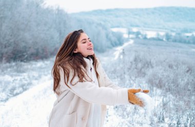 Kartopu oyunu. Karla oynamak ve kış parkında eğlenmek. Kış yolculuğunda gülümseyen kız. Kış tatilinde kartopu oyunu. Havanın ve karın tadını çıkarıyorum.