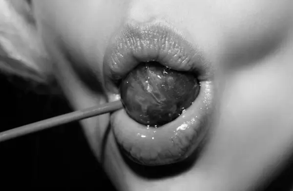Sucking lips. Lips with candy, sexy sweet dreams. Female mouth licks chupa chups, sucks lollipop