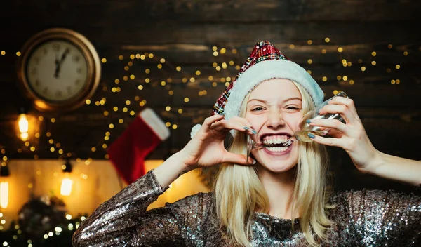 Christmas woman. Give a wink. Crazy comical face. Christmas home atmosphere. Funny Laughing Surprised Woman Portrait. Holly jolly swag Christmas and noel. Friendly and joy