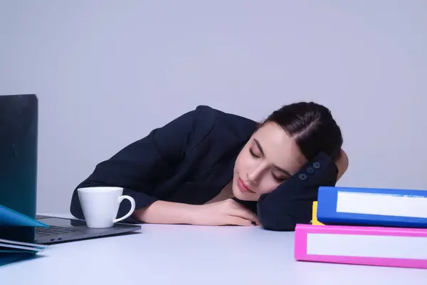 Sleeping secretary. Overworked sleeping Business woman. Young woman sleep at working place in office. Businesswoman sleeping on the desk. Sleeping office office employee