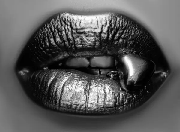 Sensual golden woman lips. Womans gold lip. Female mouth close up with golden lipstick