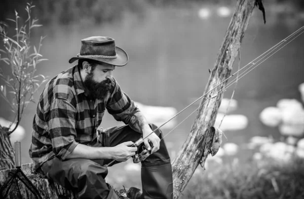 Fishing hobby and summer weekend. Bearded men fisher with fishing rod