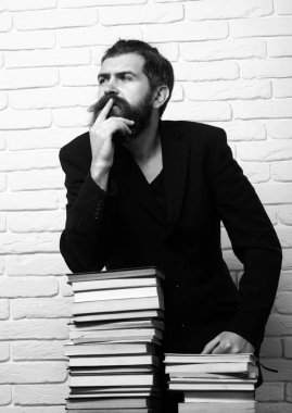 Thinking man. Portrait of a funny teacher or professor with book stack. Thinking serious mature teacher. Mature professor, middle aged teacher, bearded man with books for exam. Study concept