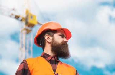 Portrait of worker man at construction site. Building and construction site concept