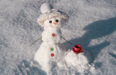 Snowman with cup coffee. Snow man isolated on snow background