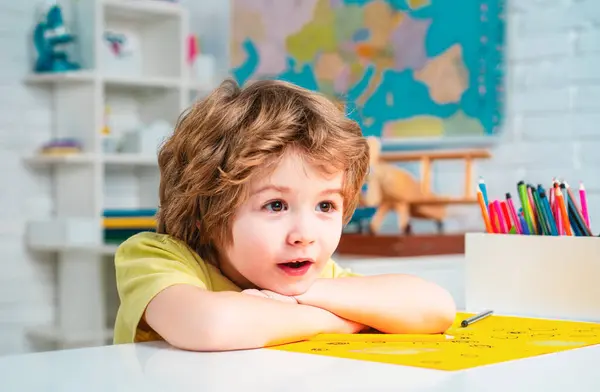 Cute face of pupil, close up. Learning and education concept. Cute child boy in classroom