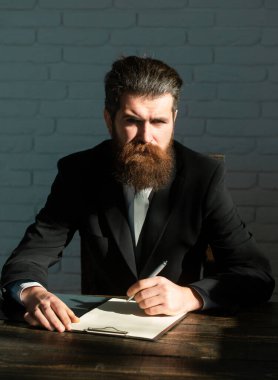 Man teaching near chalkboard in classroom. Exam in college or university. Teacher or professor at classroom. Satisfied serious mature teacher. Mature professor, middle aged teacher man