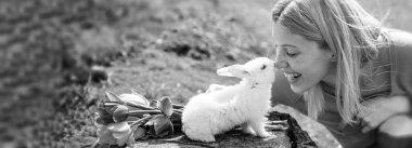 Spring woman face for banner. Alice in Wonderland. Easter Bunny. Lovely woman hold white rabbit. Happy easter