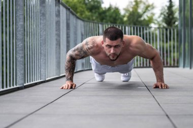 Fitness man in the gym. Young muscular man workout. Man with sexy strong body, strength and motivation. Fitness man at workout in gym pumping up muscles. Fitness and bodybuilding health