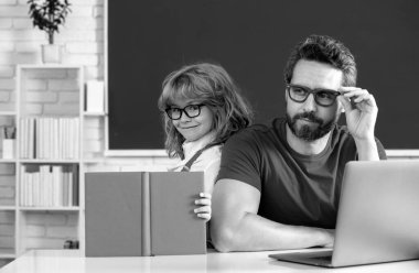 Teacher and pupil boy learning in the classroom. Teacher and little student portrait, teachers day
