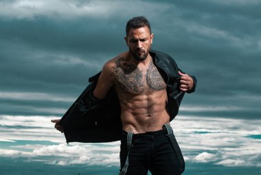 Moda erkek modeli, deri ceketini çıkar. Acımasız adam, yakışıklı, ciddi erkek model.