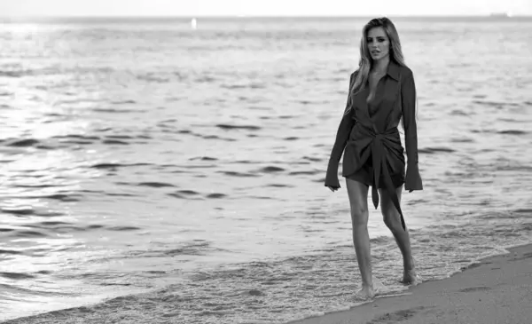Woman walking on sea beach. Beautiful woman on summer sea beach background