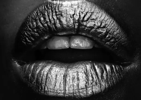 Gold lips, golden gloss lipstick. Golden lipstick closeup. Lips with metal makeup. Sexy lips, Metallic lipstick close up