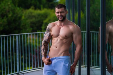 Sportsman muscular man workout in gym. Athletic man exercising with dumbbell. Fitness, sports concept, sport club, fitness center. Workout in gym. Sexy guy bodybuilder with perfect muscles body