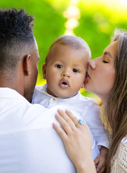 Mothers kissed baby. Close up portrait of mother kissing multiracial baby. Mother kiss child, father caring baby. Closeup face of Mother with Biracial baby kissing. Tender kiss. Mother kiss and love