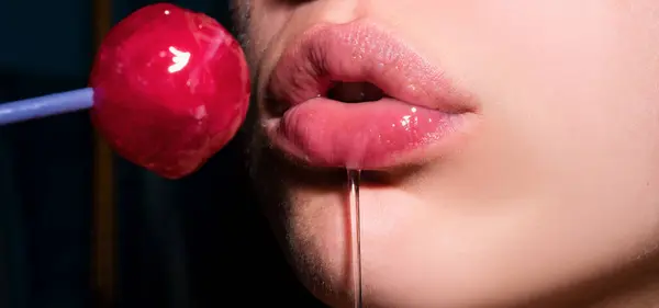 Sexy blow jobs symbol. Mouth licking lollipop, red female glossy lips and pink candy lollipop. Orgasm concept
