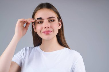 Beautiful woman with perfect shape eyebrows. Womans brows close up. Beautiful girl with eyebrow brush. Eyebrow correction. Long eyelashes and thick eyebrows