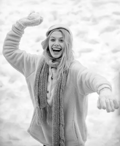 Happy winter time. Cute playful young woman outdoor enjoying first snow. Portrait of a happy woman in the winter. Cheerful girl outdoors