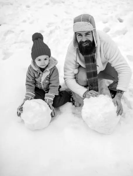 Christmas Celebration holiday. Fathers day. Christmas holidays. Father and son play in winter clothes. Winter portrait of dad and child in snow Garden. Enjoying nature wintertime